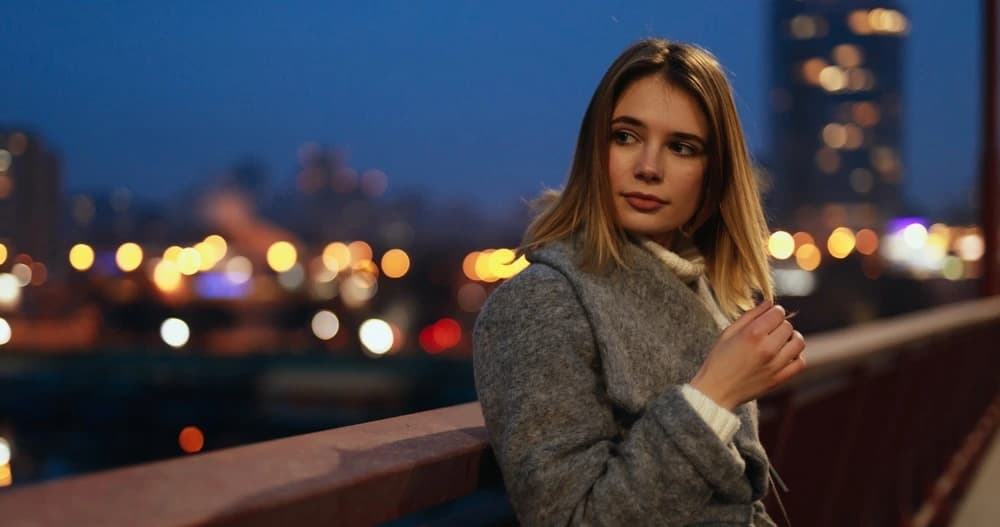 Woman with hair blowing in NYC wind on a city street