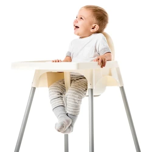 Toddler sitting in highchair